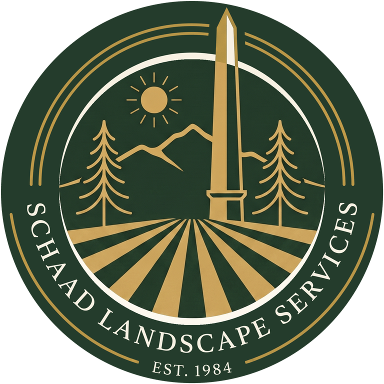 Schaad Landscape Services crest — the Bennington monument over pines and mown field rows, established 1984
